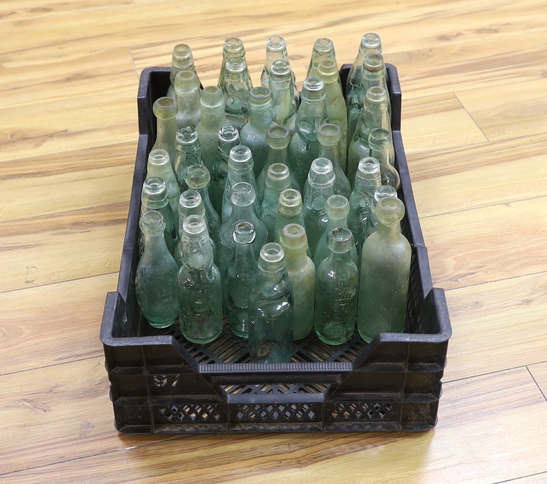 A quantity of early to mid 20th century glass bottles